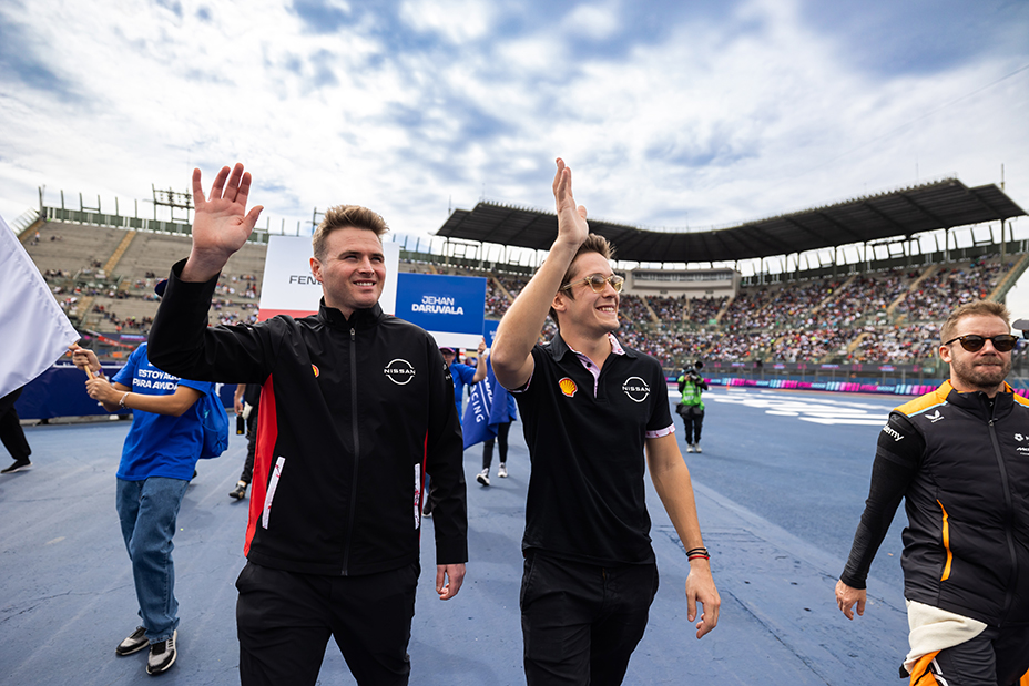 Two men waving at a Formula E event